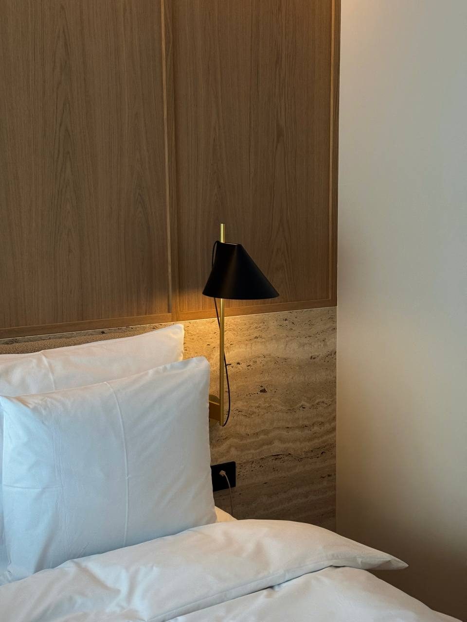 PURO Hotels Warsaw — travertine and warm wood interior, frame 3