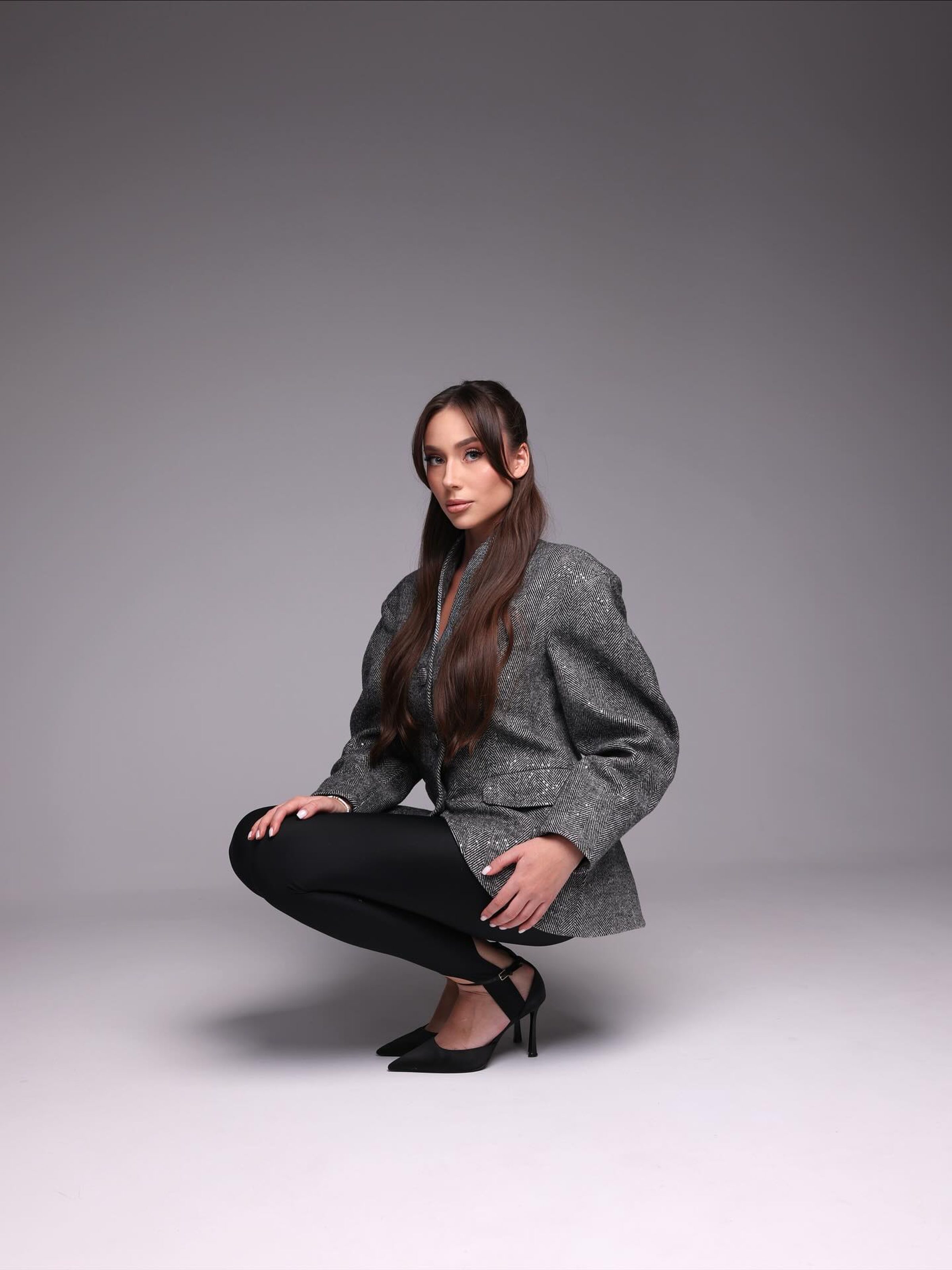Studio editorial portrait, tweed tailoring, direct gaze
